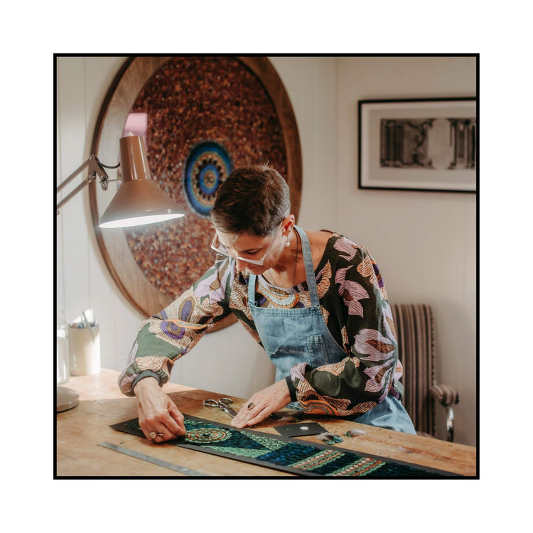 Artist Fiona Kerr Gedson working on one of her feather artworks in her home studio