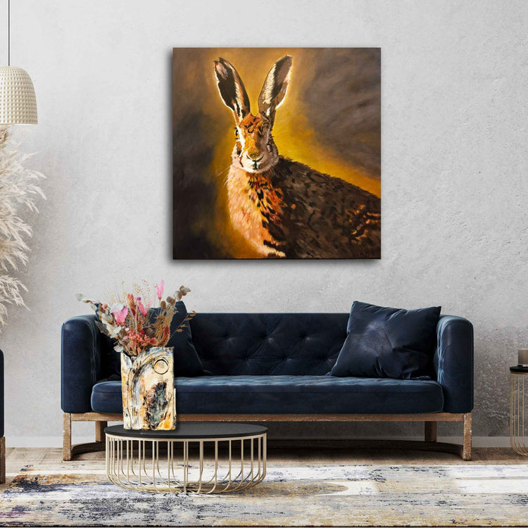 Painting of a hare staring at the camera in a living room mock up, artist Liz Petrie