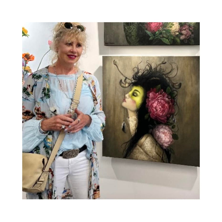 Artist Teri Parat in front of one of her paintings.