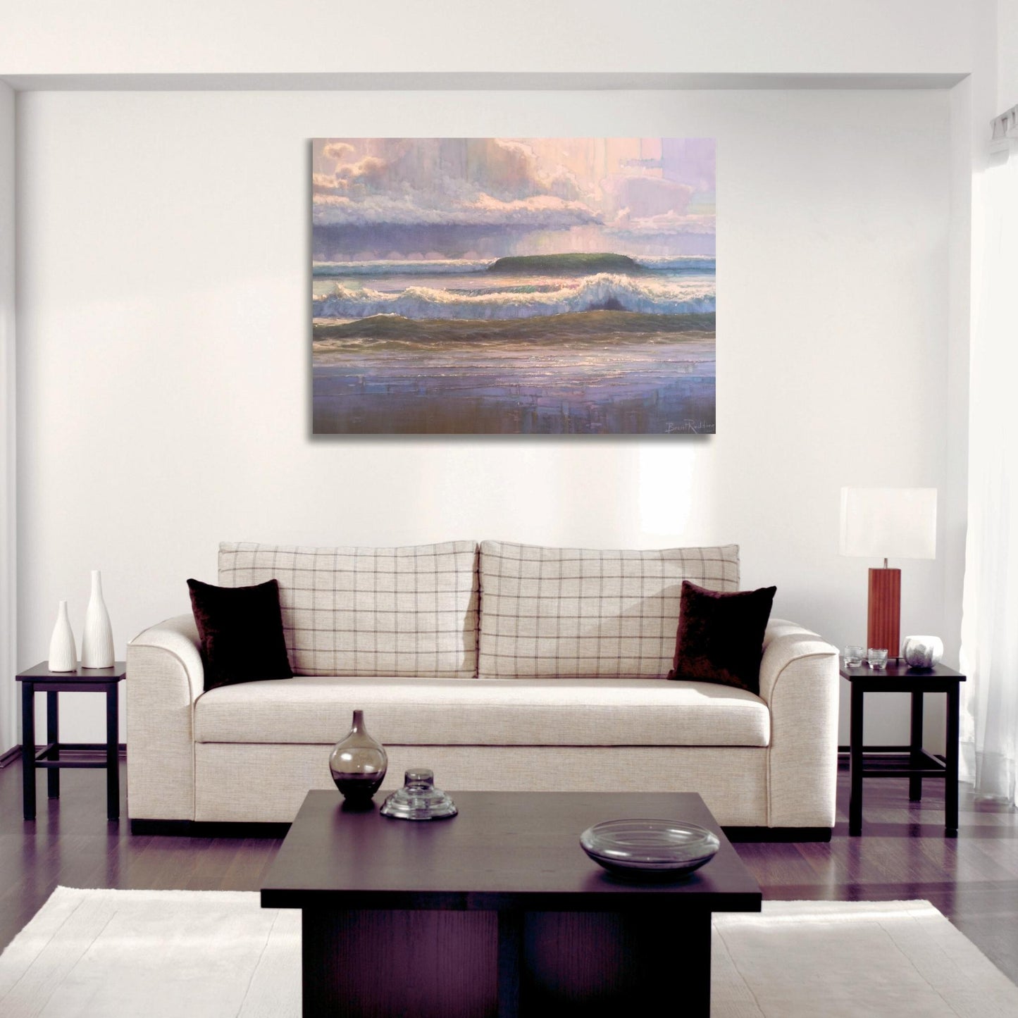 Brent Redding’s seascape painting “After the Storm” hanging in a modern living room above a neutral sofa.
