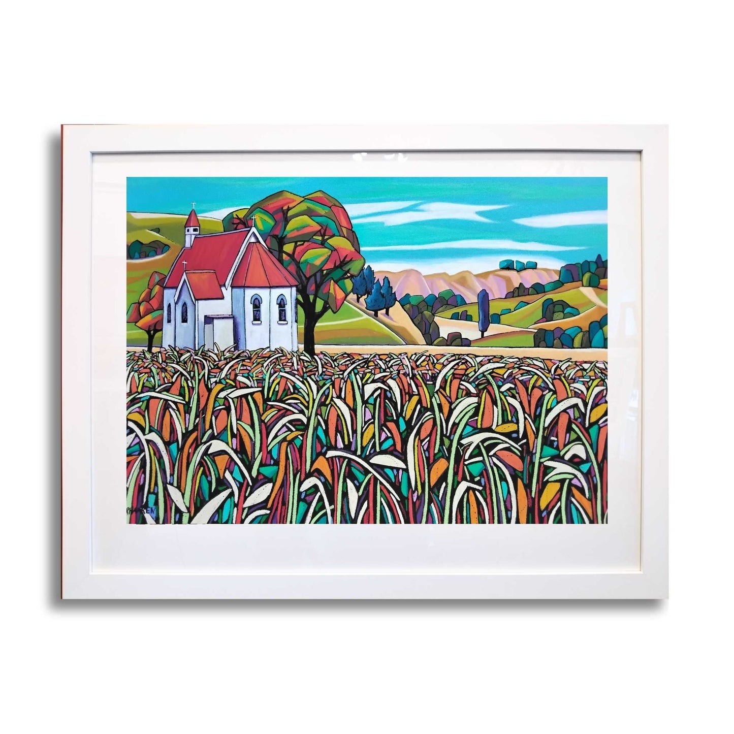 Framed artwork of a colorful landscape with the Waimarama Church and cornfield, by artist Helena Verhaaren