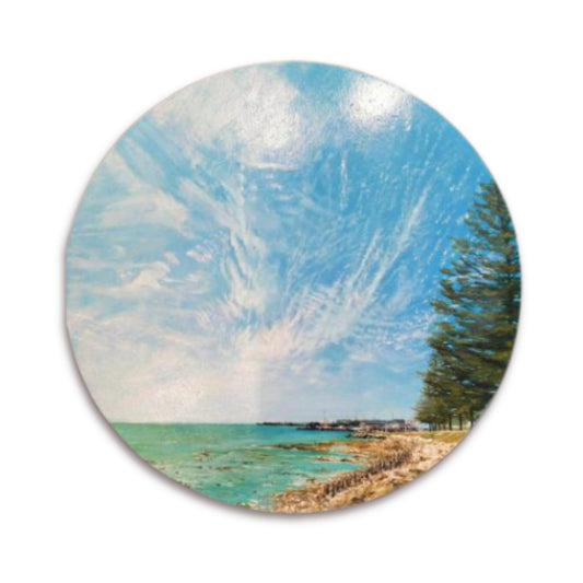 Original round painting of Hardinge Road and Napier Port by Bari Duncan, featuring windswept pine trees, rocky shoreline, and a soft cloudy sky on white background