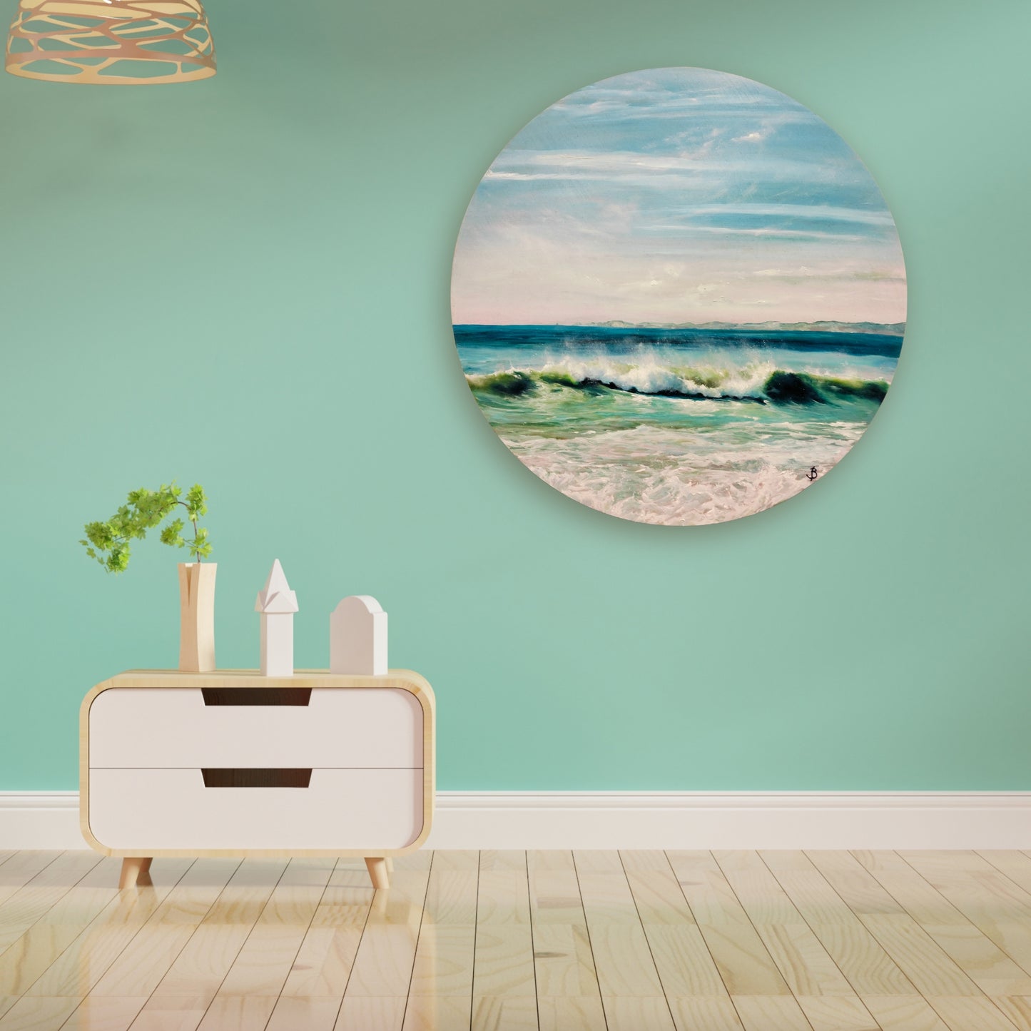 ocean painting on a round board in soft aqua and blue tones by Bari Duncan, displayed in a lifestyle mockup, lounge setting