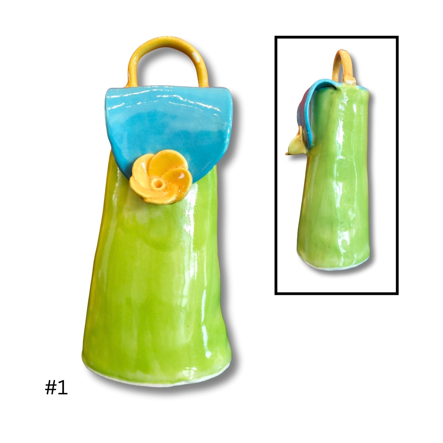 Green ceramic purse with blue top and yellow handle on a white background