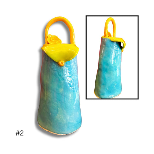 Blue and yellow ceramic purse with a small inset showing a close-up.