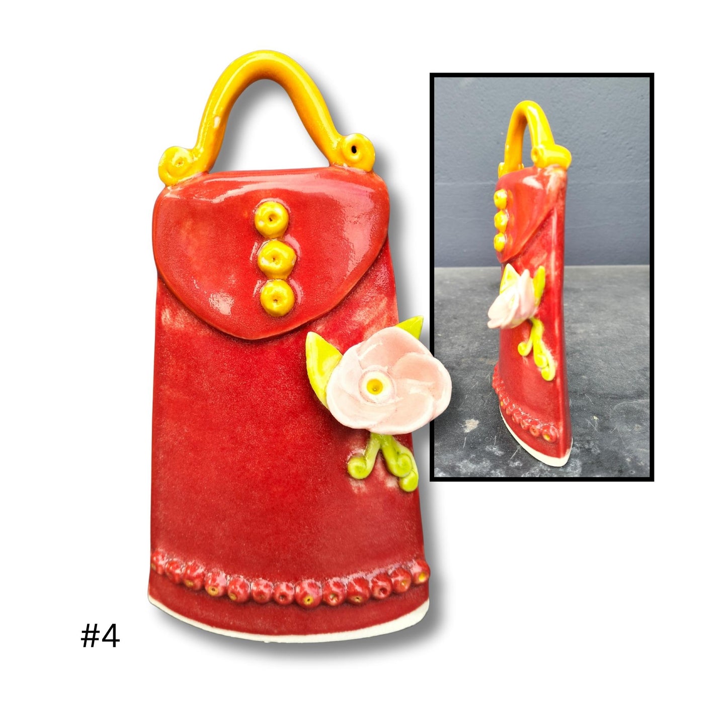 Red ceramic bag with yellow accents and a small pink flower on a white background