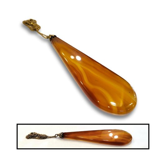 Close-up showing translucent orange carnelian stone with natural markings.