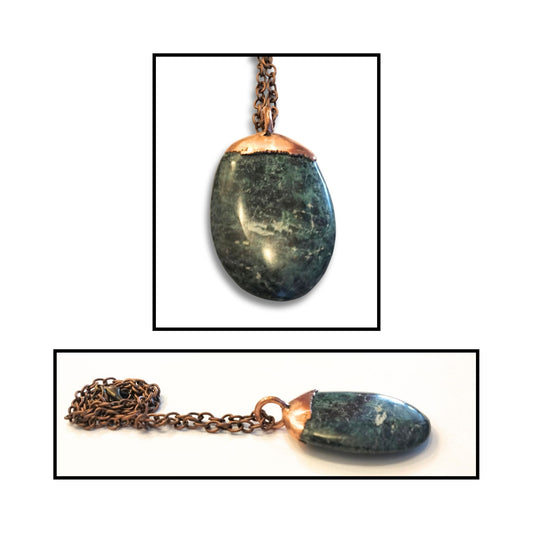 Close-up of the greenstone pendant showing copper top and ring bail.