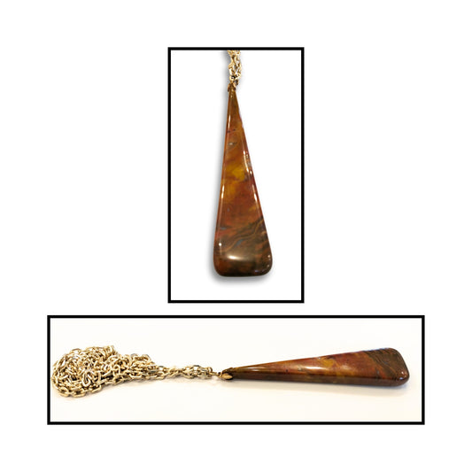 Close-up of natural jasper pendant showing earthy colour variations and smooth taper.