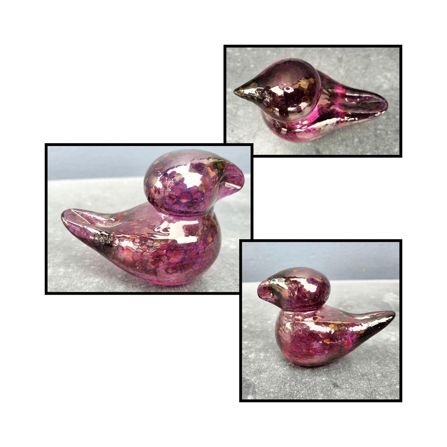 Handblown maroon glass bird by Heather Kremen with smooth curves and glossy finish