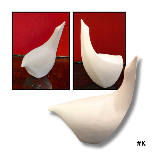 White Earthenware ceramic bird no.k showing three angles on a red background