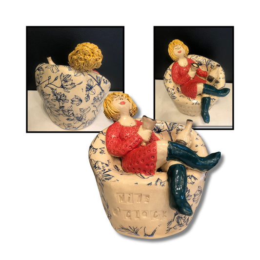 Close-up of Wine O'Clock ceramic sculpture B, showing intricate hand-painted details and whimsical character holding wine glass