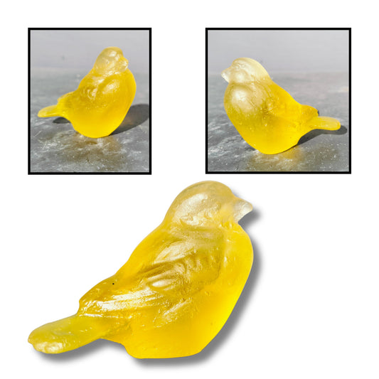 Cast glass bird sculpture in bright translucent yellow by Lou Mathieson, 7x4x5cm, shown on white background