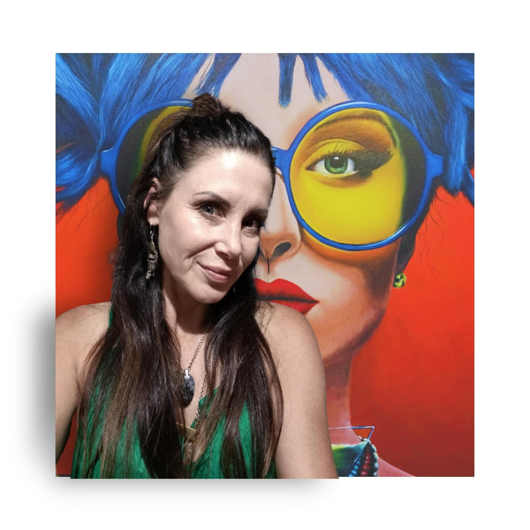 Donna-Lee standing in front of her latest vibrant painting, showcasing her bold new style