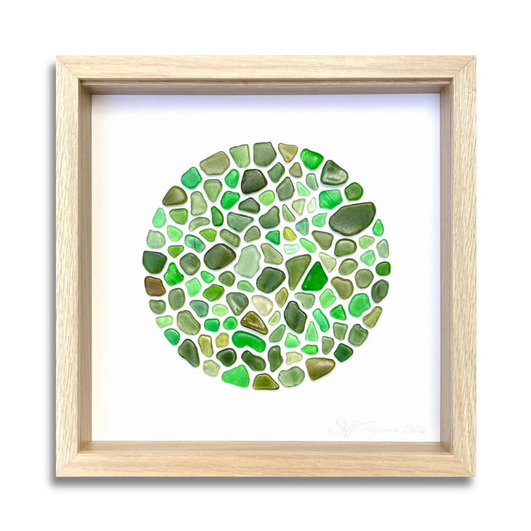 Framed circular sea glass art in soft coastal tones by Steffi Tregenna