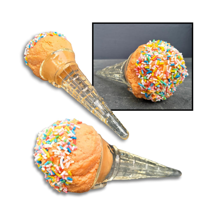 Playful orange ice cream sculpture with colourful sprinkles and a clear acrylic cone – a nostalgic nod to childhood summers and classic dairy treats