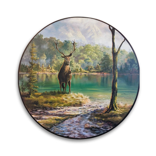 Round painting of a tranquil river stream flowing into a lake, with a stag standing on the grassy bank in the foreground, surrounded by native bush and a soft sky—artwork by Maree White.