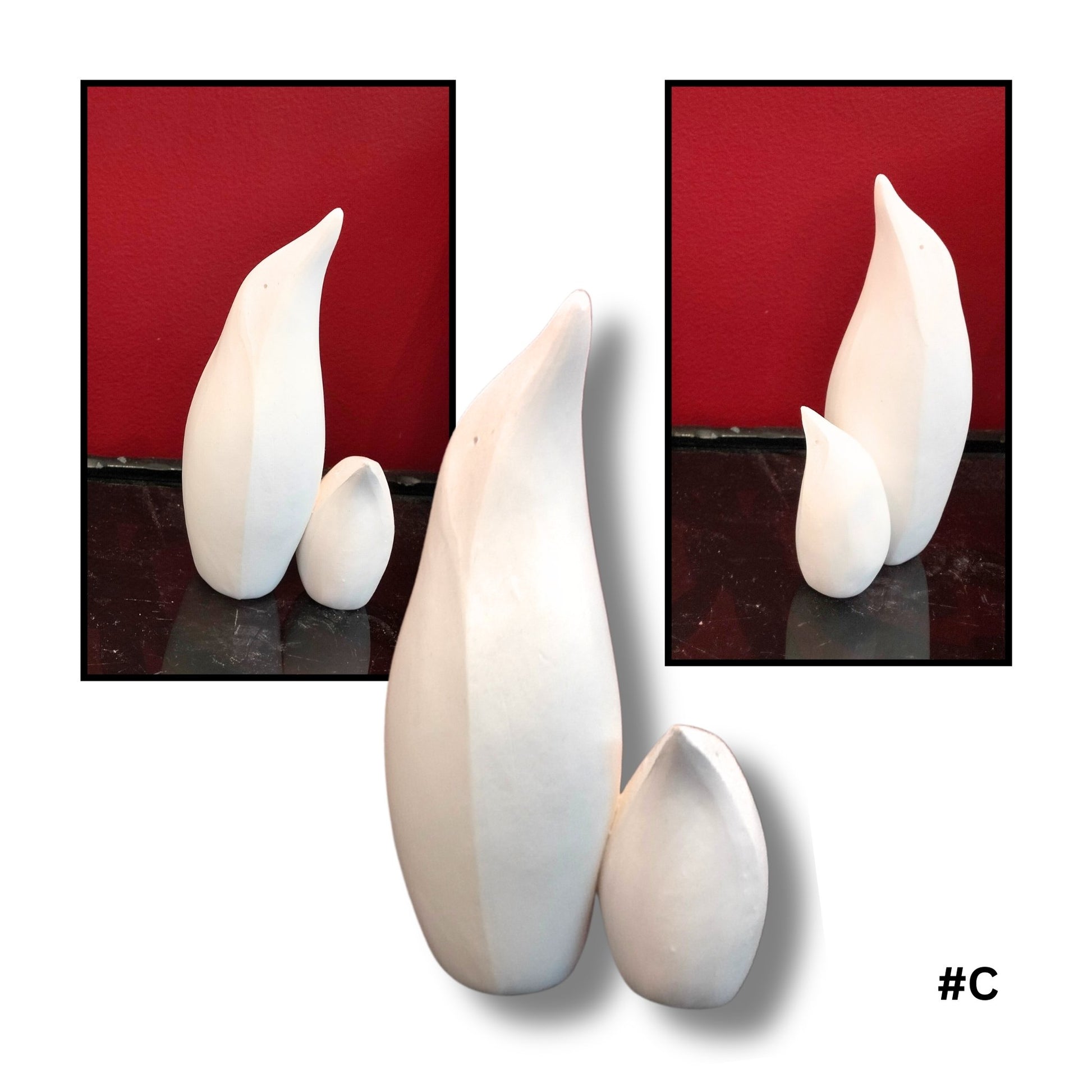 Mother and child White Earthenware Clay Penguin sculpture C, showing three views on a reflective surface with red background