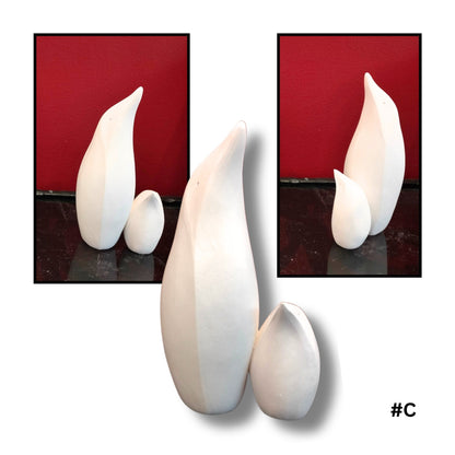 Mother and child White Earthenware Clay Penguin sculpture C, showing three views on a reflective surface with red background
