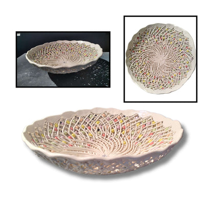 Intricate handmade ceramic lattice bowl by Tom Somerville with interwoven detail and colorful accents. Clay, 34 × 34 × 10cm. Sculptural craftsmanship and delicate beauty.
