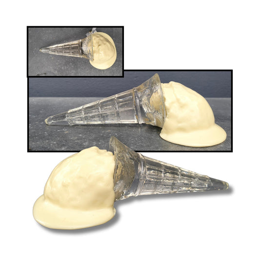 A sideways vanilla ice cream sculpture with a glossy white puddle and a clear cone, titled “Oophs.”