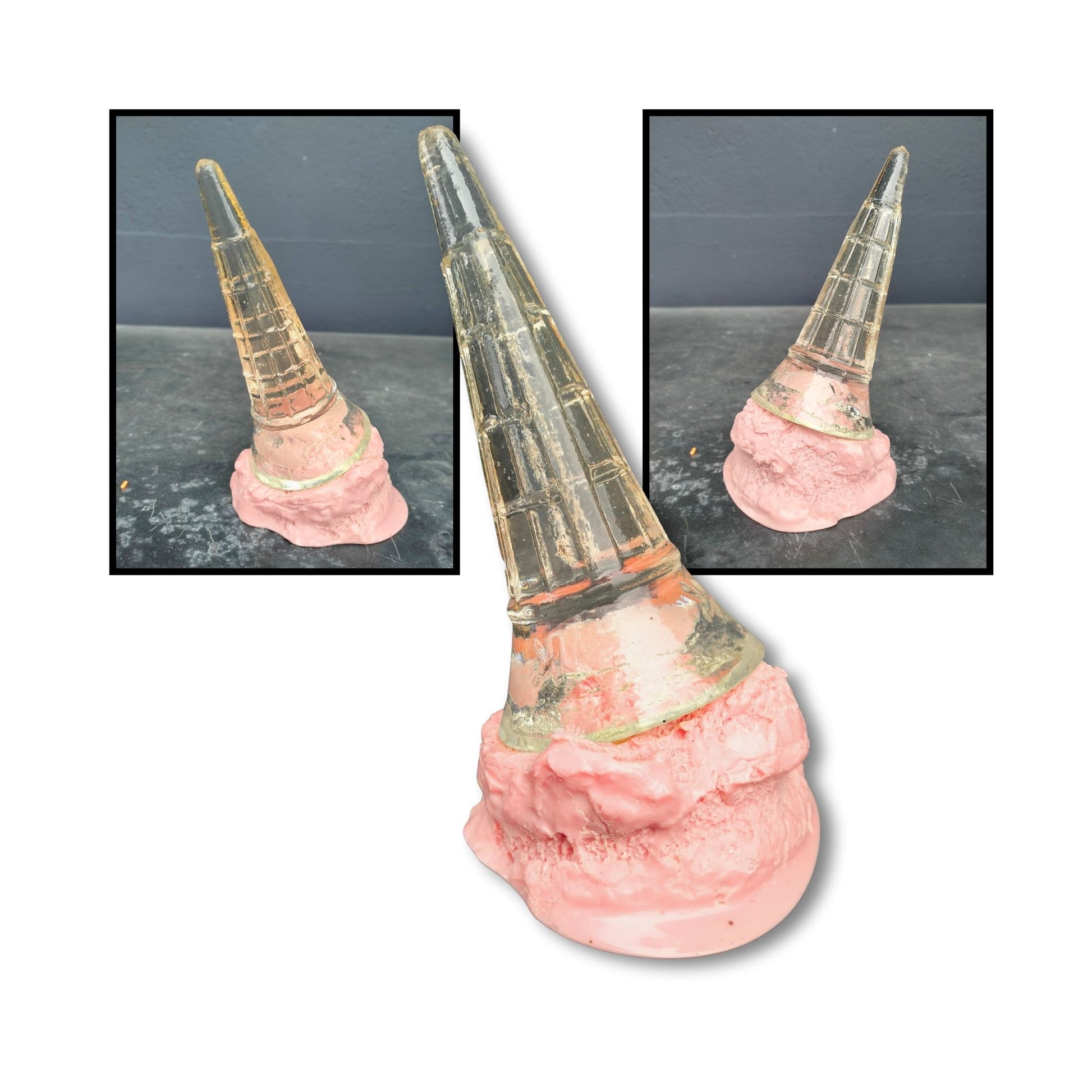 A whimsical pink strawberry ice cream sculpture with a tipped transparent cone resting in a melted swirl of sweetness.