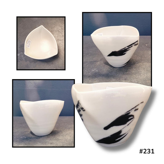 Altered Bowl with Feather Strokes #231 by Lyn Rigg, with a softly triangular rim and sweeping black feather-like markings on creamy porcelain, shown from above and several sides.
