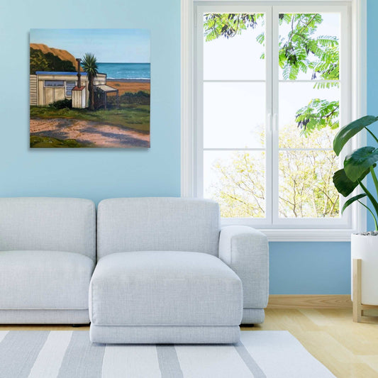 Bach Tangoio by John Staniford – framed artwork mockup featuring an acrylic New Zealand coastal painting in a styled interior setting.