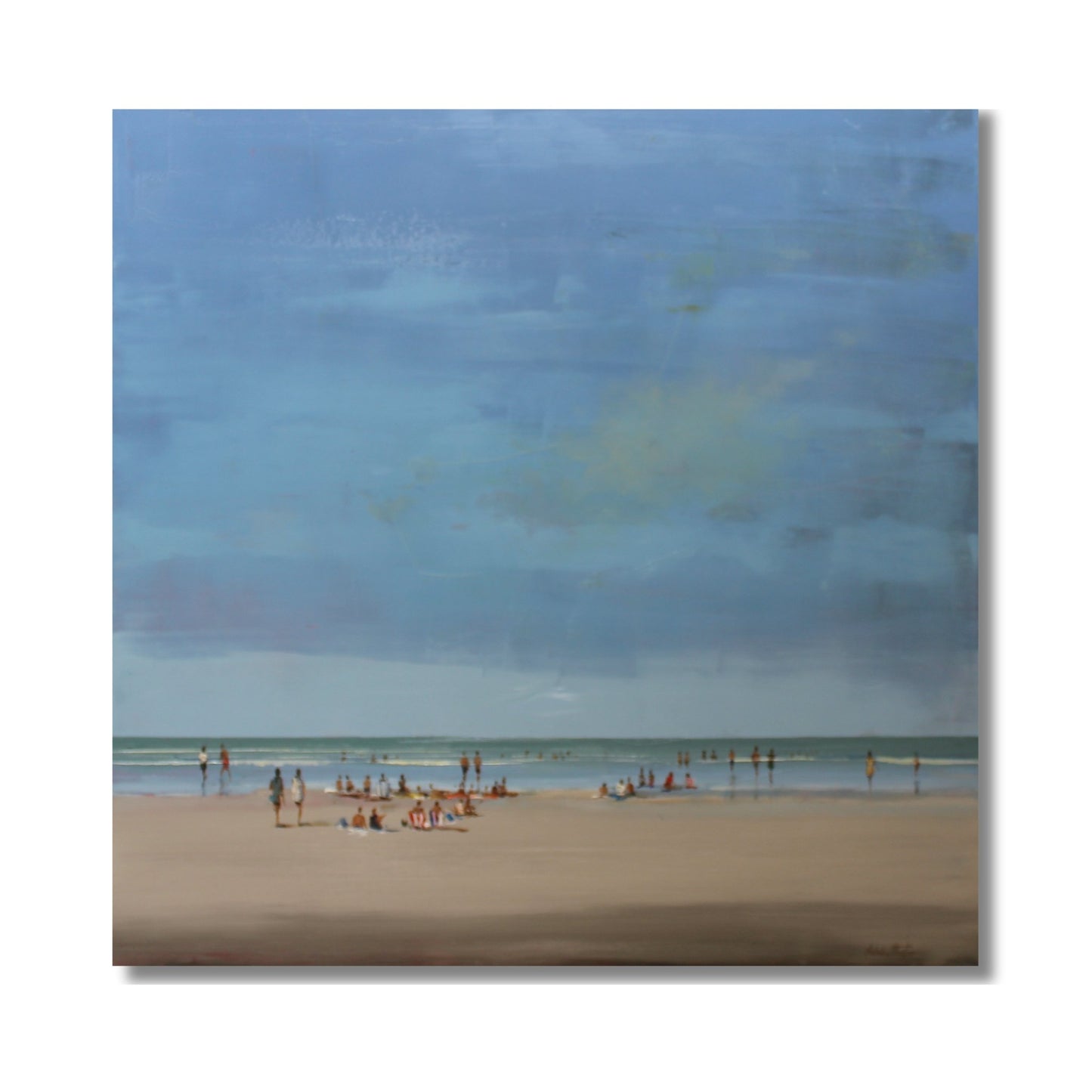 Beach Chill oil painting by Nicholas Hayter showing a serene beach scene with soft blue sky, turquoise water and people enjoying the shore, framed in white box frame
