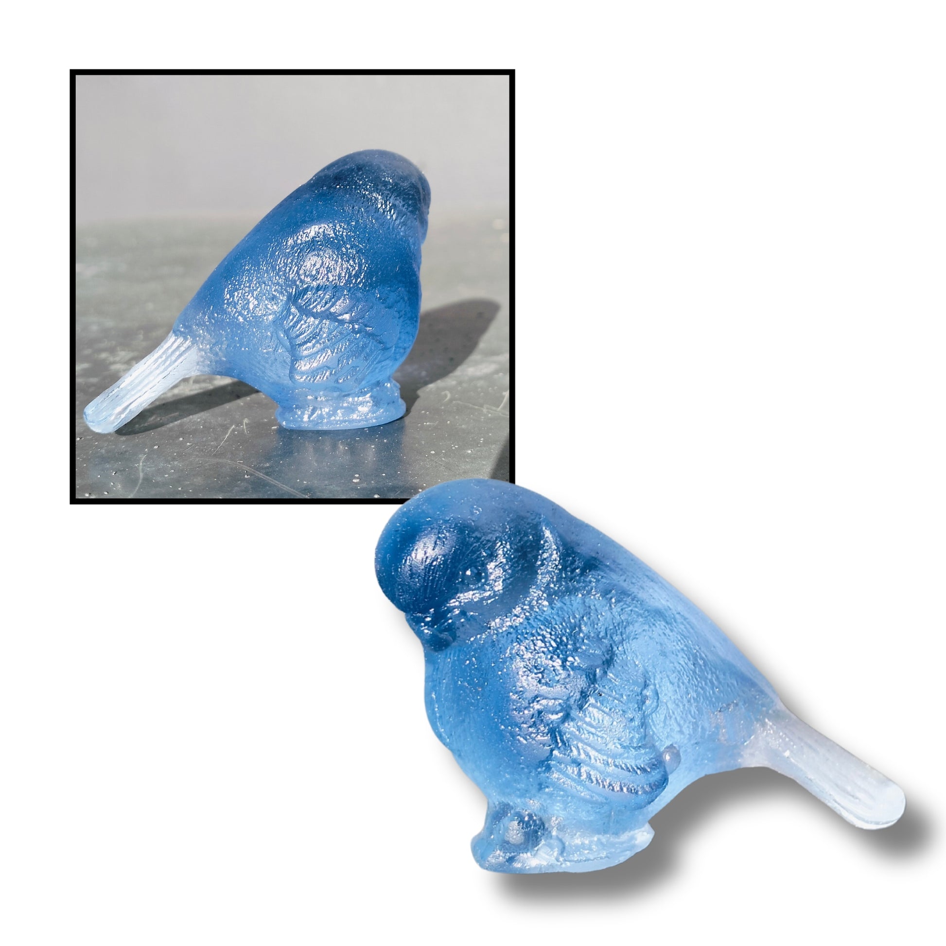 Small cast glass bird sculpture in blue with tail down by Lou Mathieson, 5x4x4cm, on white background