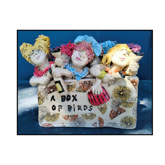 Box of Birds by Mandy Olson – ceramic sculpture of lively women figures on a white background.”