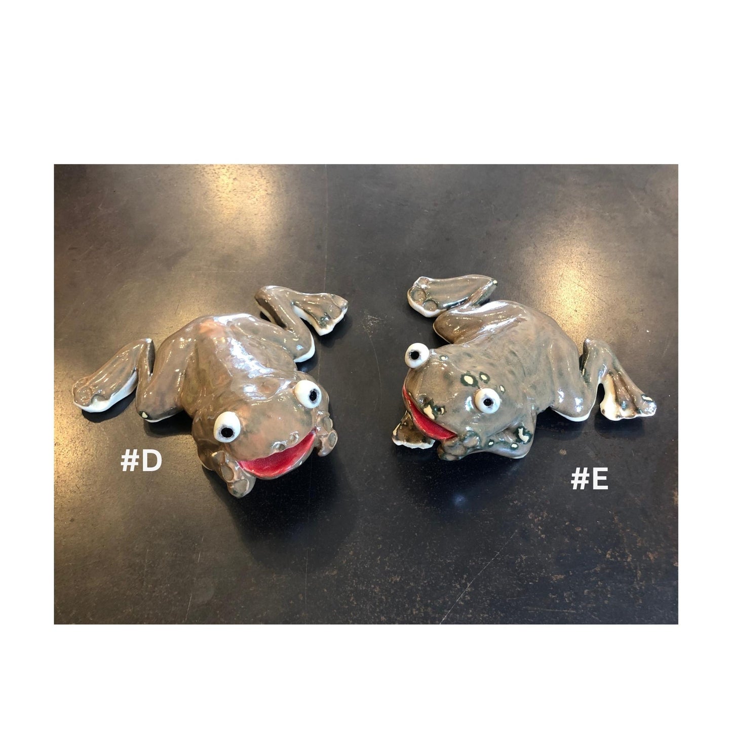 Two handmade brown ceramic frog for the garden, on a dark surface with '#D' and '#E' labels.