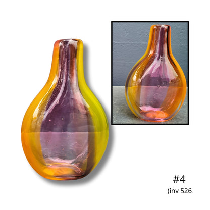 Glass vase with gradient color in a display setting