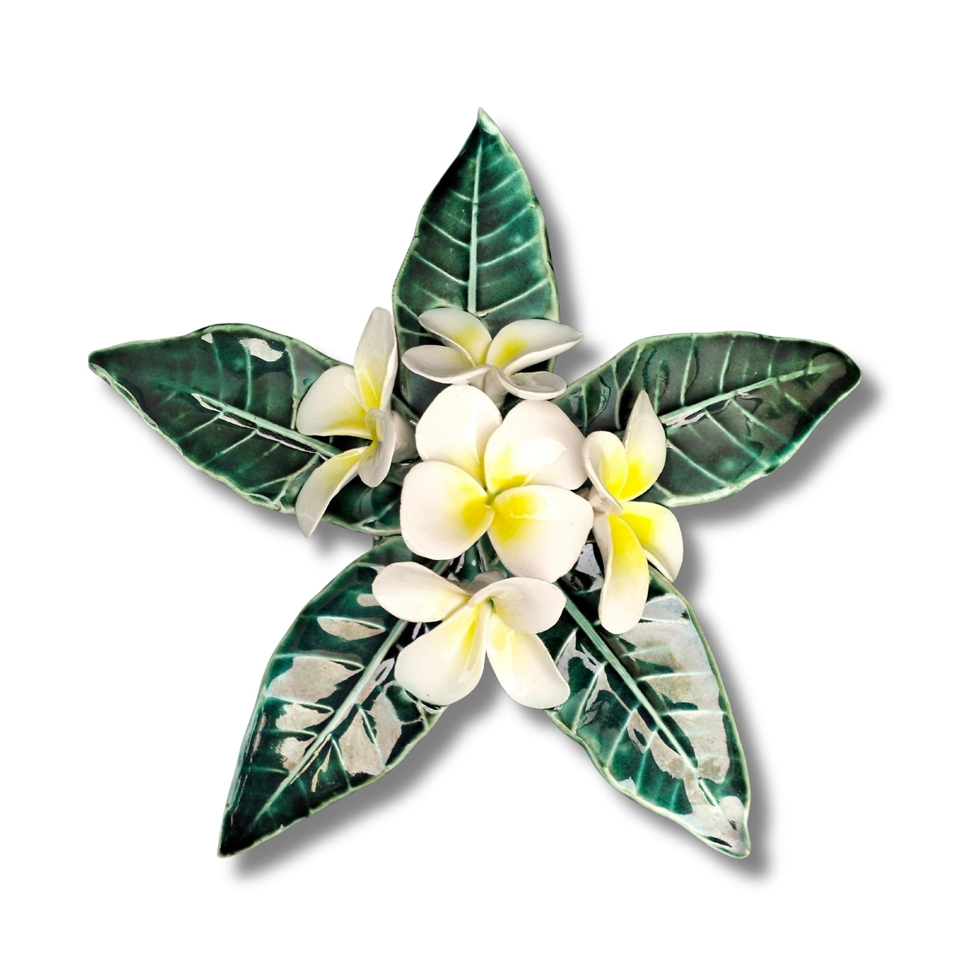 Three-dimensional ceramic Frangipani Wall Hanging by Tom Somerville with white flowers, yellow centers, and glossy green leaves

