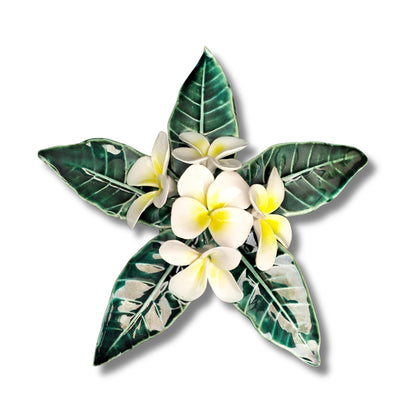 Three-dimensional ceramic Frangipani Wall Hanging by Tom Somerville with white flowers, yellow centers, and glossy green leaves
