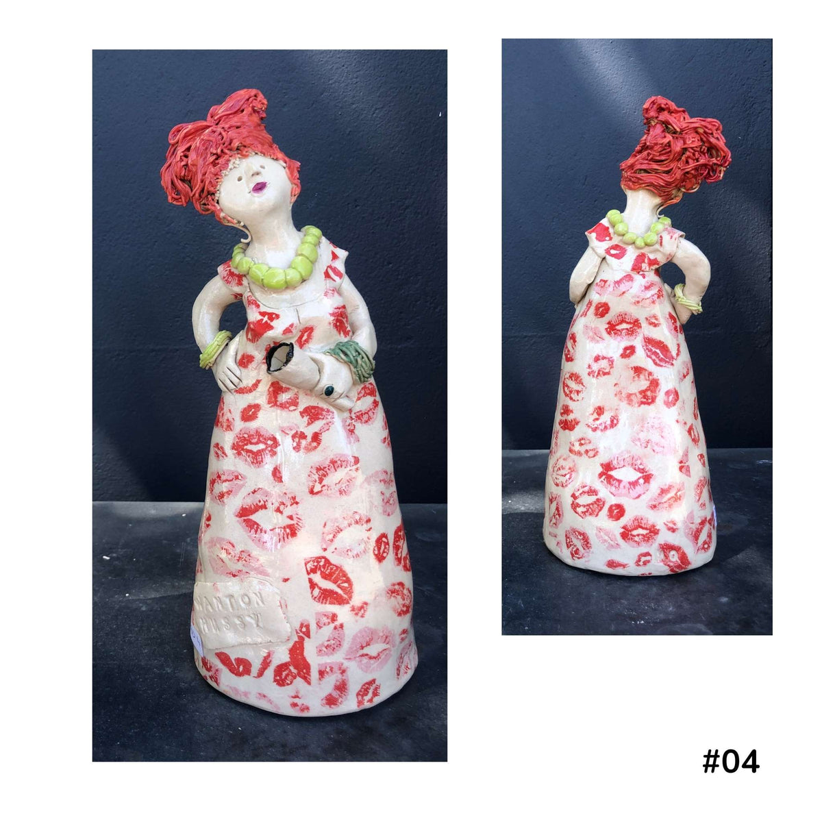 Mandy Olson’s ceramic lady 07, with reddy hair, a white dress with red kiss shape pattern, she is holding a wine glass , shown from the front and back.