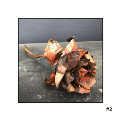 Handcrafted copper rose sculpture #2 with layered petals in coral and bronze tones on white background