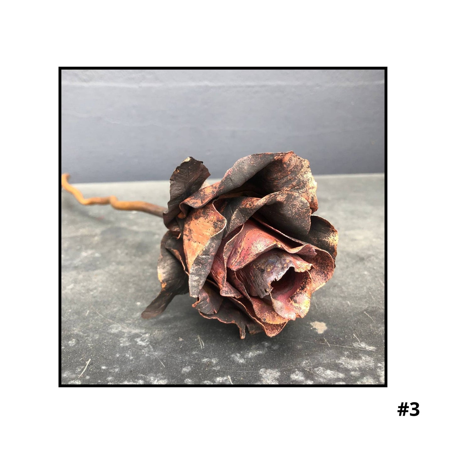 Handcrafted copper rose sculpture #3 with layered petals in coral and bronze tones on white background