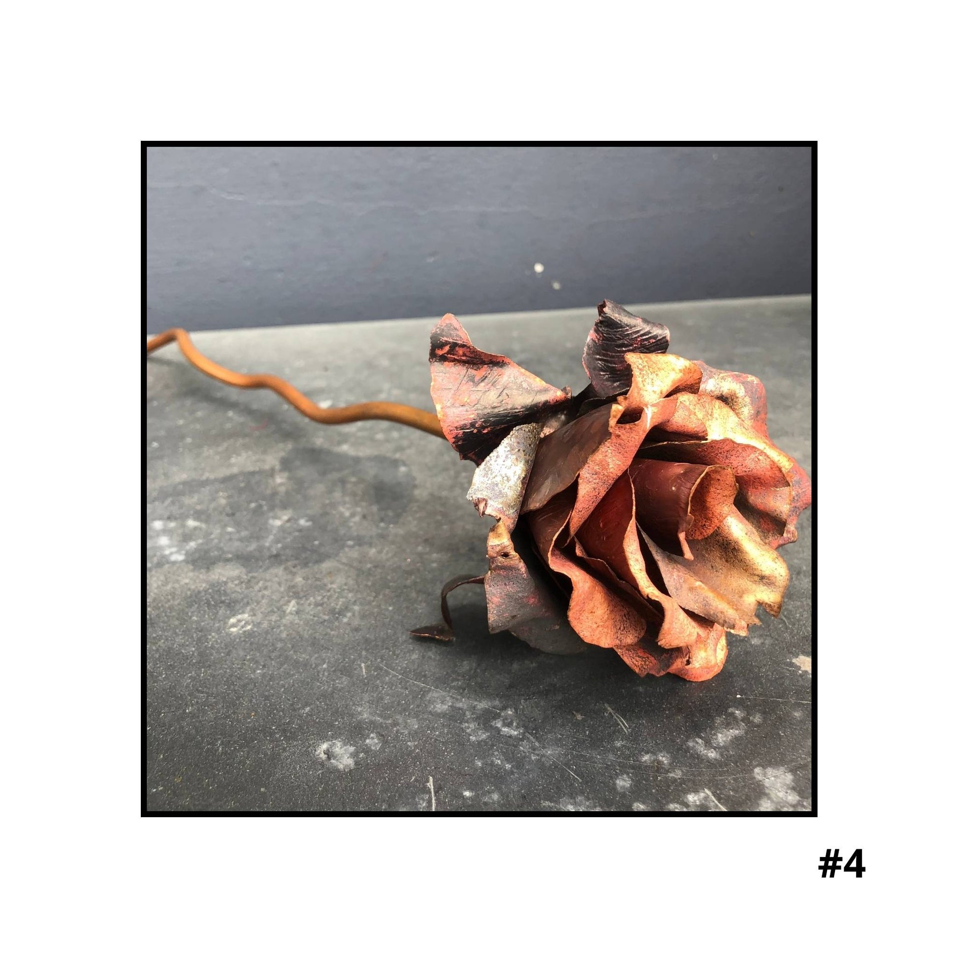 Handcrafted copper rose sculpture  #4 with layered petals in coral and bronze tones on white background