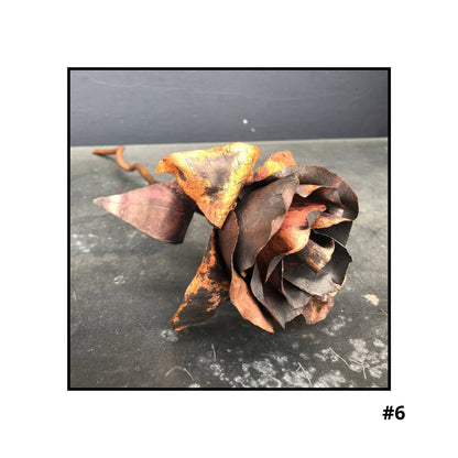 Handcrafted copper rose sculpture #6 with layered petals in coral and bronze tones on white background