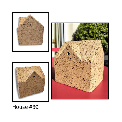  Dormer House ceramic sculptures by Greg Melville, number 39, each with unique roof angles and slab‑built forms casting shadows.