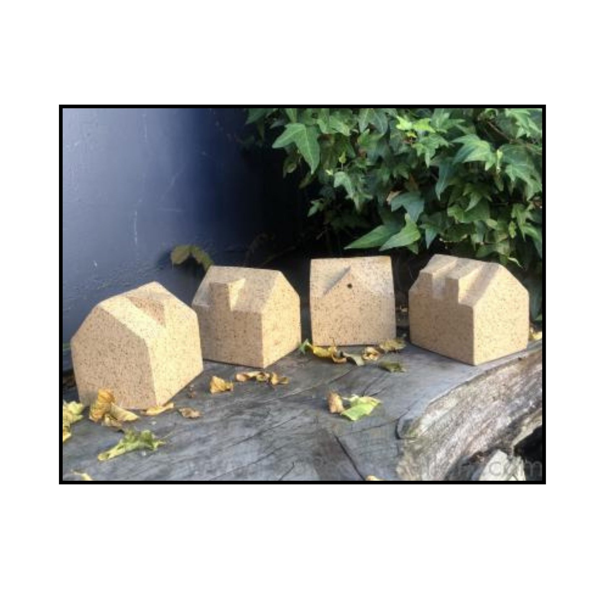 Variants  39-42 of Dormer House ceramic sculptures by Greg Melville, each with unique roof angles and slab‑built forms casting shadows.