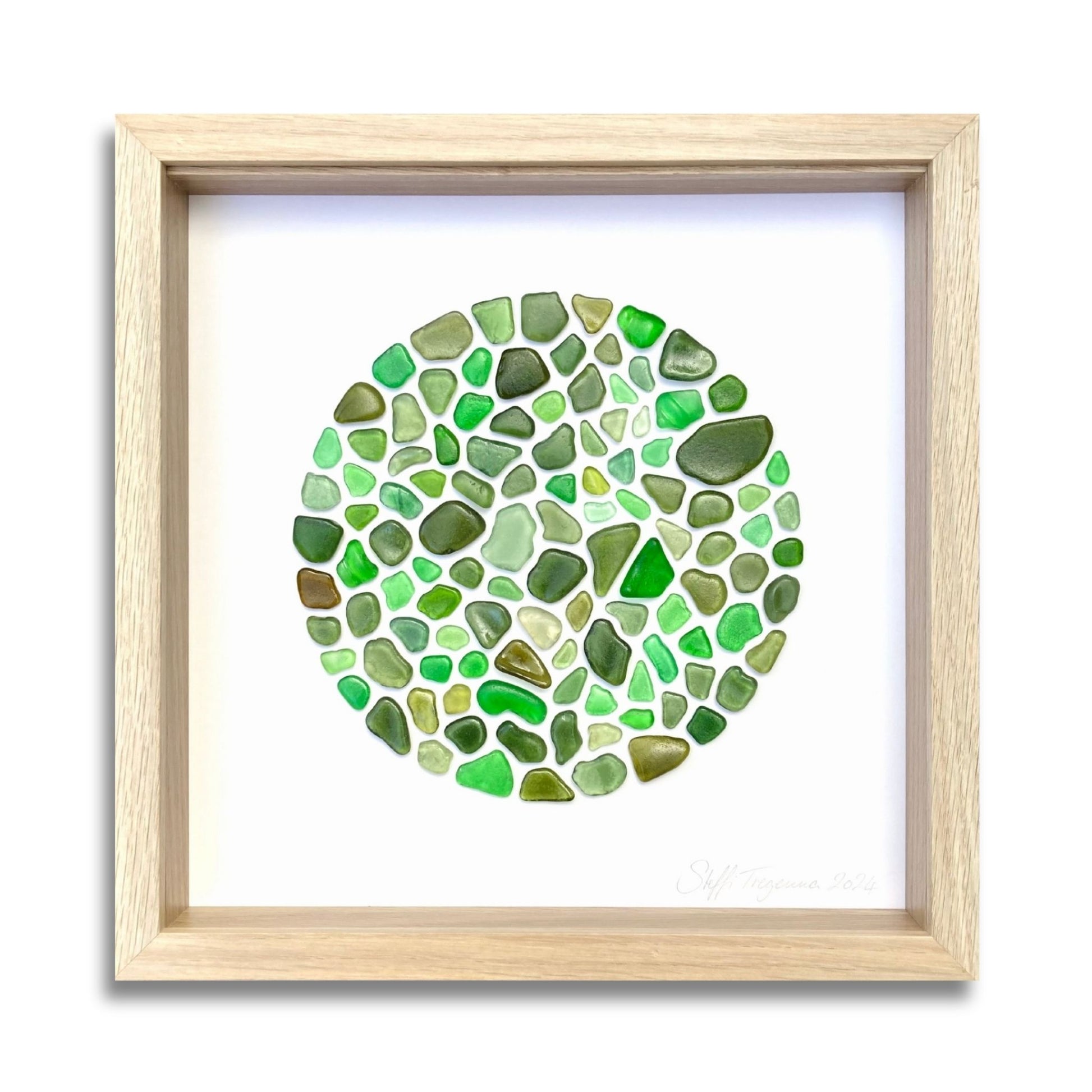 Framed circular green sea glass art in soft coastal tones by Steffi Tregenna