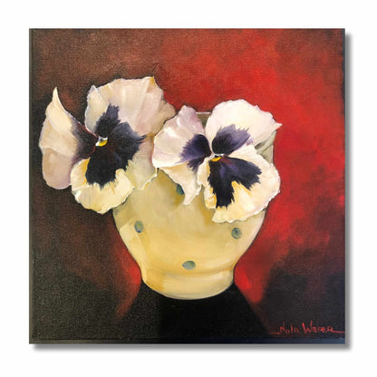 Original oil painting of two white pansies with dark centres in a yellow polka-dot bowl against a deep red background, by New Zealand artist Nola Weber, 30 × 30cm.