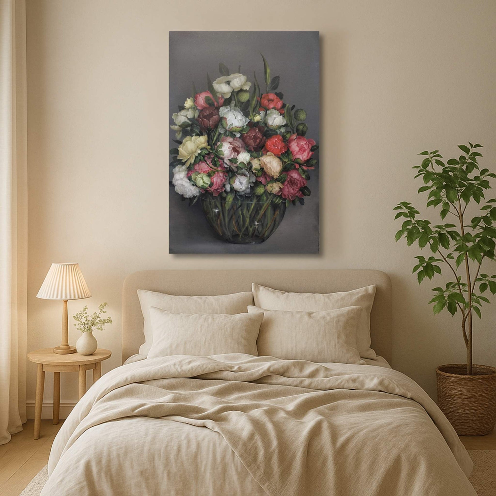 Bedroom with floral painting above the bed, lamp, and plant.