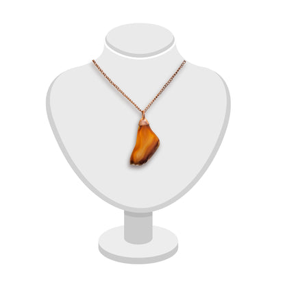 Carnelian agate pendant in warm amber tones with copper bail by Gary Howse, shown on a jewellery bust.