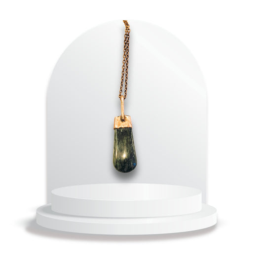 Copper and greenstone pendant by Gary Howse displayed on a white jewellery stand, showing the natural greenstone framed by a warm copper cap and bail.