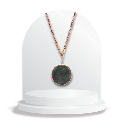Round greenstone pendant with copper ring setting by Gary Howse on chain.