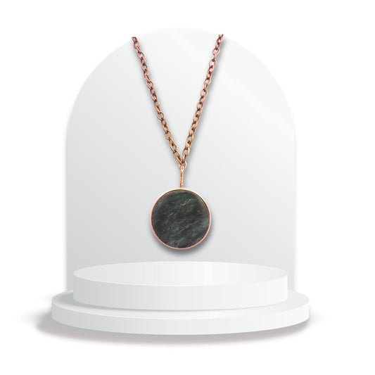 Round greenstone pendant with copper ring setting by Gary Howse on chain.