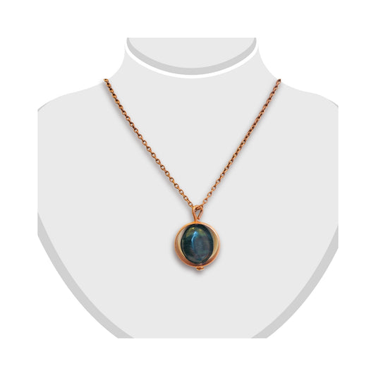 Handmade greenstone pendant suspended in a copper ring by Gary Howse, shown on a display bust.